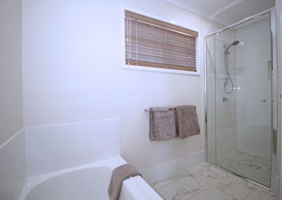 Cararra Gloss Porcelain Floor Tiles Bath & Shower Remodel in Guest Bathroom