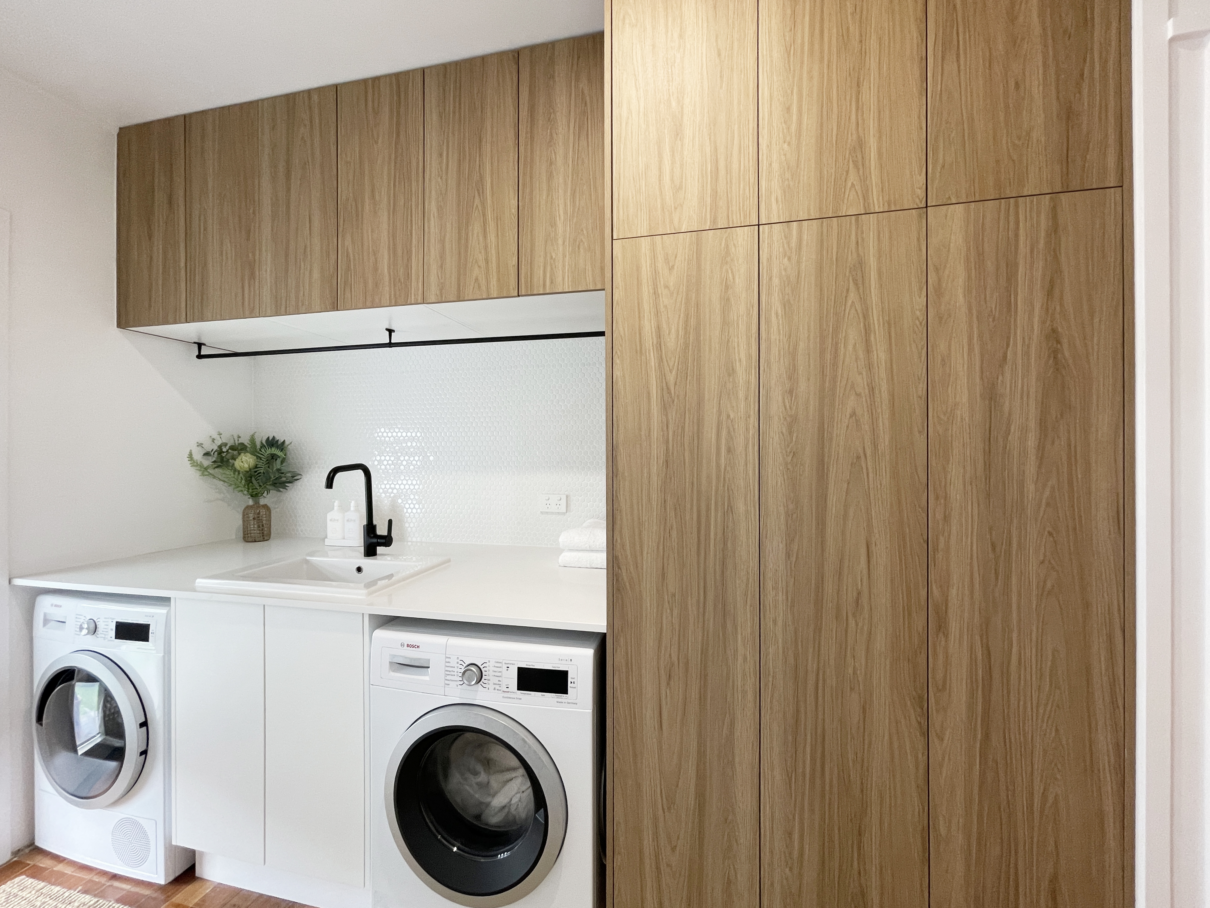 Ultimate laundry linen storage - Floor to ceiling custom woodgrain cabinetry